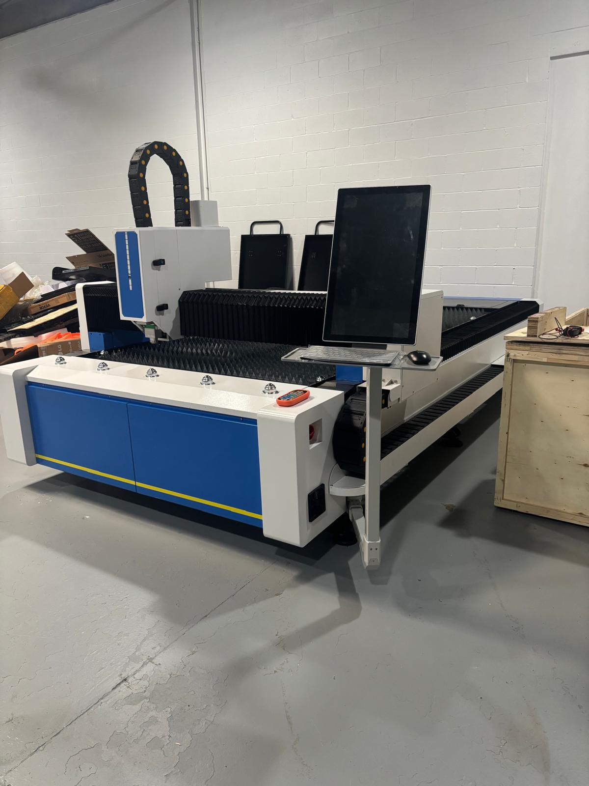 UmproTech machine deposit for 3kw model featuring monitor and cutting surface in workshop environment.